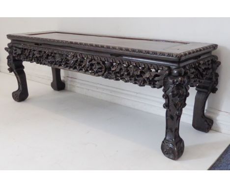 A late 19th century Chinese hardwood low table of rectangular form: the gadrooned top of good polished colour and patination 