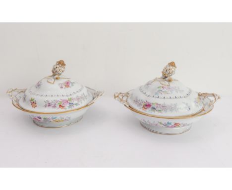 A pair of 19th century two-handled serving tureens: each with a gilded bud and leaves finial above floral sprays and sprigs d