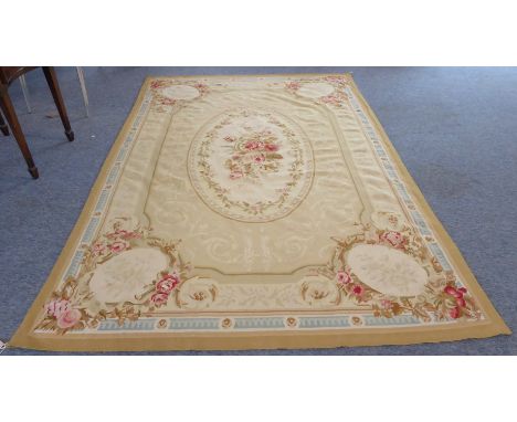 A fine and large Aubusson tapestry: central cream oval with a spray of roses surrounded by scrolling acanthus and four oval s
