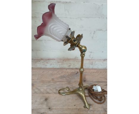 An early 20th century railway carriage brass angle lamp with pink and frosted glass shade, height 48cm.