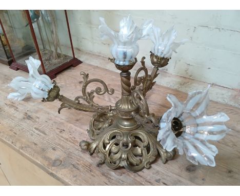 A cast brass ceiling light fitting with opaline glass shades, length 65cm.