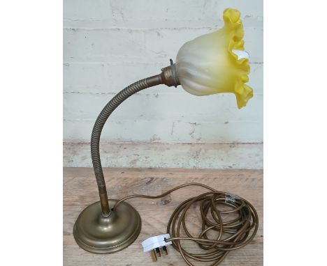 An early 20th century brass angle lamp by GEC (General Electric Company, with yellow and frosted glass shade and weight base,