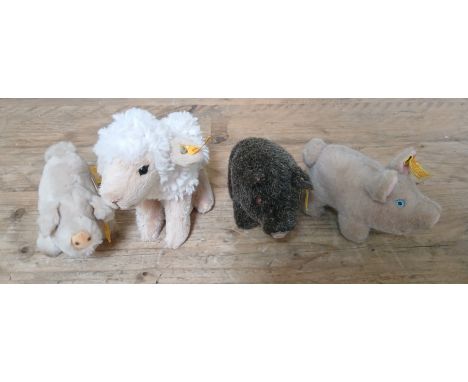 Three Miniature Steiff pigs and a Steiff sheep.  