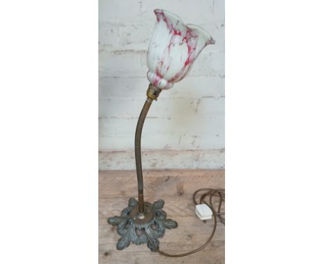 An early 20th century brass angle lamp with mottled glass shade, height 63cm.