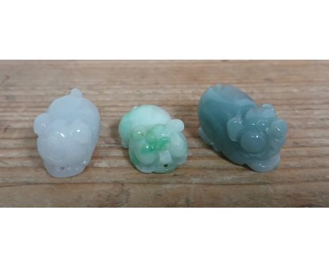 A group of three Chinese caved jade pigs.
