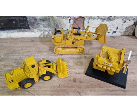 Three NZG Caterpillar models comprising of a wheel-type loader no. 167, a track-type loader &amp; a diesel engine no. 183.
