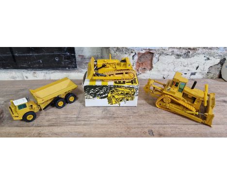 Three model costruction vehicles comprising of a NZG DJB D300 articulated dump truck no. 166, a Gescha CAT D9 track-type trac