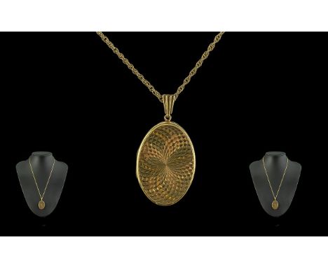 Attractive 9ct Gold Engine Turned Locket with 9ct Gold Chain. Both Chain and Locket Marked 9.375. The Double Sided Hinged Loc