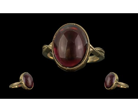 A Good Quality 9ct Gold Single Stone Ruby-Lite Set Ring - The Large Cabochon Cut Ruby Lite of Pleasing Red Colour with Slight