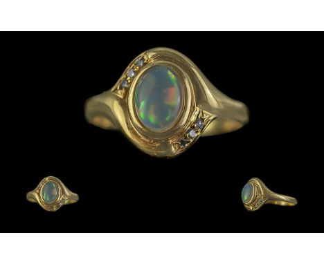 18ct Gold Attractive Opal and Diamond Set Ring. Marked 18ct to Shank. The Central Opal of Good Colour with Six Small Diamonds