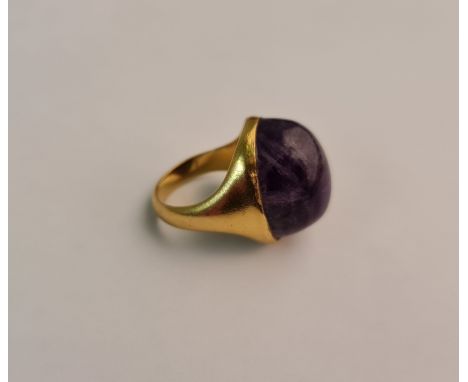 An amethyst cabochon ring, stamped 22ct, ring size J. approx. weight 10.9gms