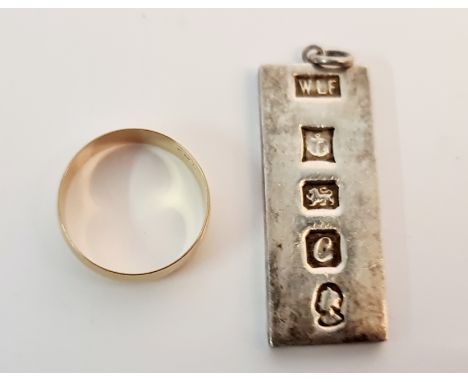 A hallmarked 9ct yellow gold wedding band, ring size X approx. weight 3.5gms, and a silver ingot