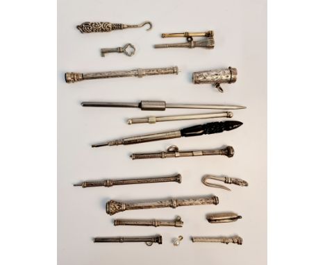 A collection of metal gem set propelling pens and loop, button hooks, key