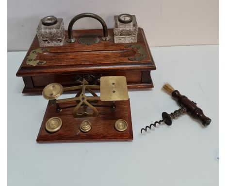 A oak desktop inkwell set of brass scales and corkscrew.