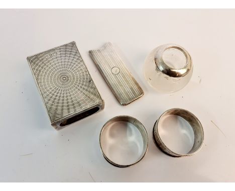 Hallmarked silver to include a card holder with elephant monogram, a match stick holder, together with two decorative napkin 