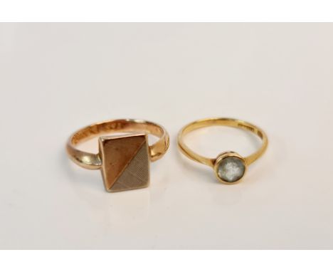 A hallmarked 9ct yellow gold signet ring, together with an aquamarine single stone ring, stamped 18ct.