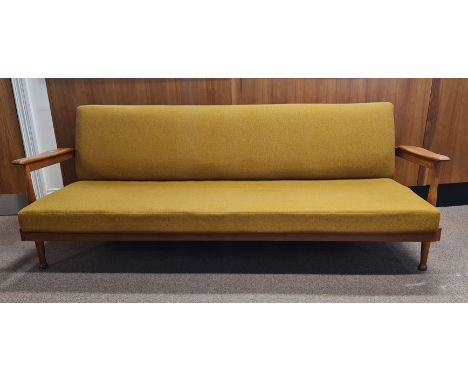 A Guy Rogers Manhattan teak sofa bed and two armchairs.