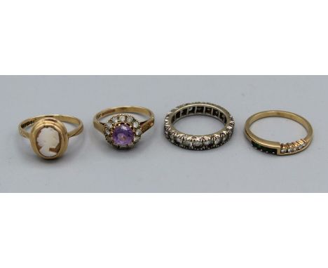 A selection of four rings comprising a 9ct gold amethyst and cubic zirconia cluster ring, size K, a shell cameo ring in 9ct g