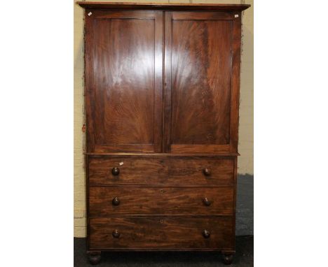 A 19th century mahogany linen press, the moulded cornice over a pair of panel doors enclosing four trays, the base with three