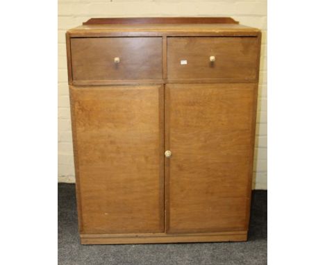 A Heals style Art Deco mahogany side cabinet having two short drawers over a pair of panel doors, w90cm