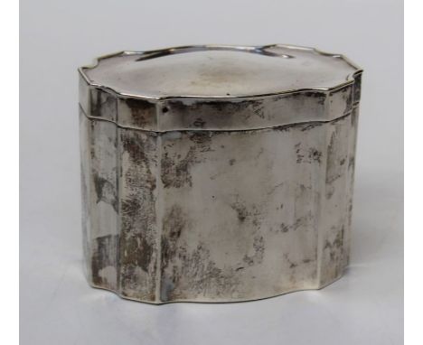 A George V silver tea caddy of re-entrant oval form, with hinged cover and gilded interior. Birmingham 1923. Makers marks rub