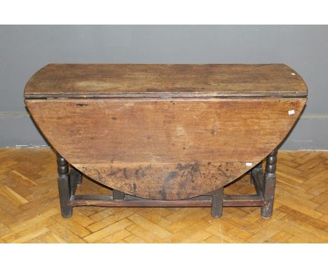 A late 18th century oak drop leaf gateleg dining table, on bobbin turned and block supports, 70 x 154 x 136cm (open)