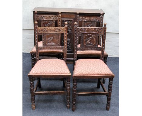 A set of eight 19th century oak dining chairs, each having ball finials over florally carved rail, arrow armorial splat, with