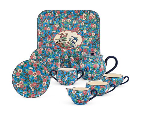 A LONGWY POTTERY TÊTE-À-TÊTE TEA SERVICE  LATE 19TH CENTURY  Painted in the Oriental style with prunus on turquoise grounds w