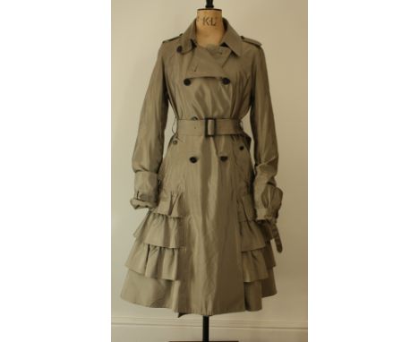 Aquascutum silk mix, khaki grey, trench coat. Features classic epaulets on the shoulders, tiered lower half and oversize pull