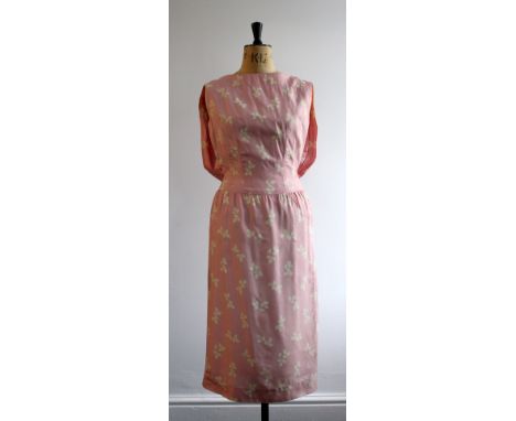 A late 40s/early 50s pink silk dress by Atrima. Back pleat detail draping over a back belt leading into a straight pencil ski