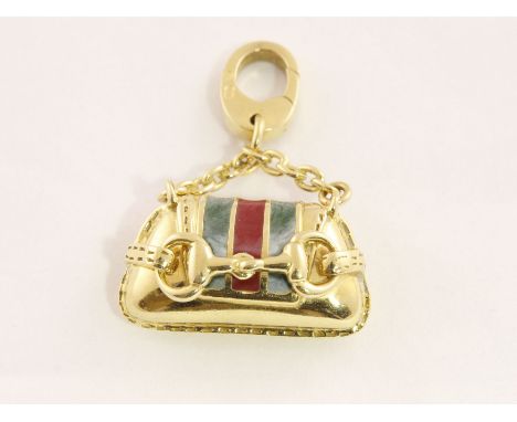 A modern 'hand bag' charm, stamped GUCCI & 750 with clip fitting & enamel decoration, approx 8.7gms