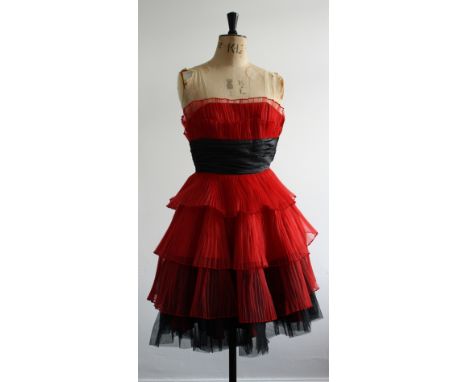 A Betsy Johnson strapless dress, with a fitted boned bodice, plisse pleated tiers and a black faux ruched sash waistband in b