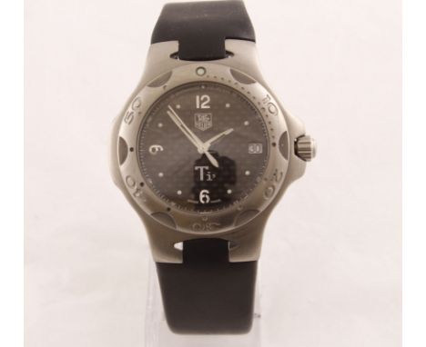A steel TAG quartz wristwatch with fitted rubber strap, model WL1181/ZJ3177, working with original box & undated papers