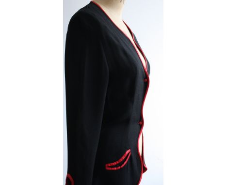 1970s Ossie Clark jacket in his signature black moss crepe with silk red satin piping. Features a daring front button fasteni