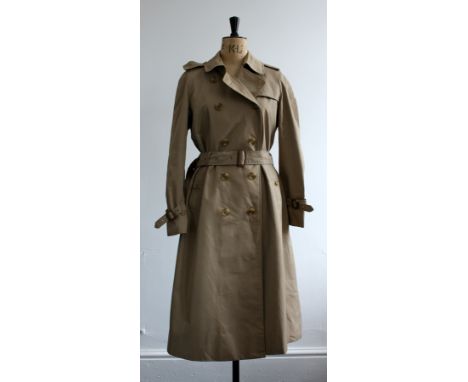 1970s Ladies Burberry trench coat in classic biege with nova check lining. All components and buttons still in tact. Classic 