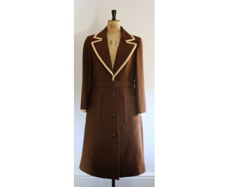 1970s overcoat by French Couture Label Jean Patou. Tailored in London. Features wide, low cut lapel collar, cream piping on t