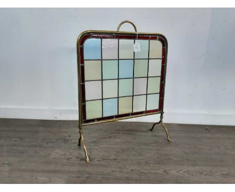 LATE VICTORIAN STANIED AND LEADED GLASS FIRE SCREEN, the screen housed in a brass frame, on splayed legs66.8cm high