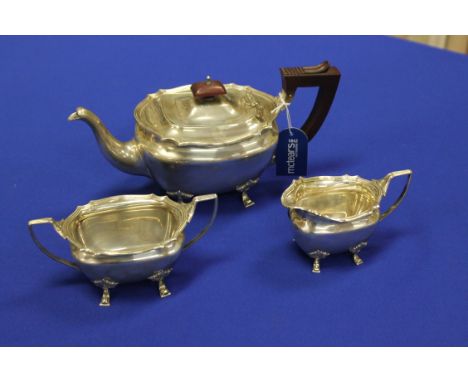 GEORGE V SILVER THREE PIECE TEA SERVICE
maker Adie Brothers Ltd., Birmingham 1930, teapot 1931, of rectangular form with serp