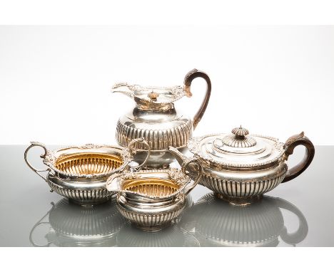 ATTRACTIVE VICTORIAN SILVER FOUR PIECE TEA SERVICE
maker Walter & John Barnard, London 1892, hot water pot 1895, of partially