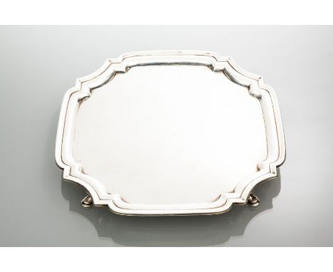 SILVER SALVER
maker T R Ltd, Sheffield 1945, of square form with serpentine rim, on four short legs, approximately 619g, 26.5