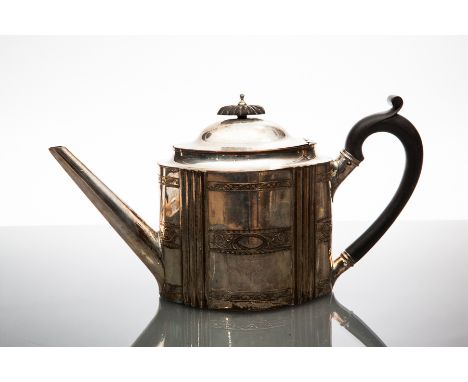 GEORGE III OLD SHEFFIELD PLATE TEAPOT
circa 1785-90, of oval Neo-classical outline, engraved with three scrolling floral bord