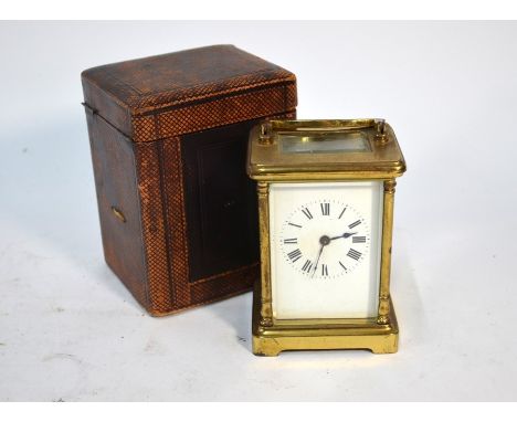 An antique brass carriage clock with white enamelled dial, in fitted leather travel case, 12 cm h a/f