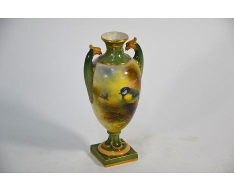 A Royal Worcester small baluster urn painted with blue tits by Ernest Barker (signed) on green and gilt ground with phoenix-h