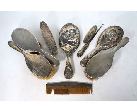 Five various silver-backed hairbrushes, a handmirror, comb, button hook and nail-buffer with silver mounts (box)