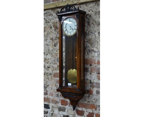 An antique redwood Vienna regulator style wall clock, with circular white enamelled dial with subsidiary seconds, brass weigh