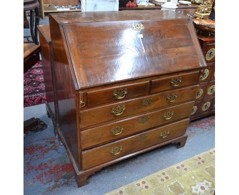 A Georgian fruitwood bureau, the fall enclosing a fitted interior over two short and three long graduated drawers, on shaped 