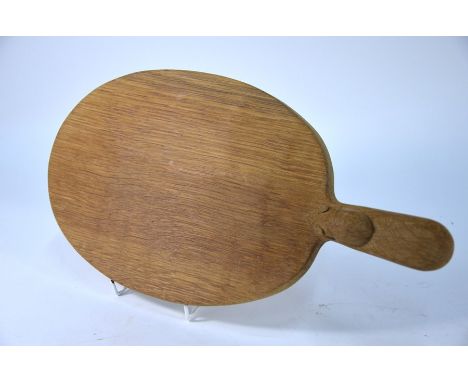 A Thompson of Kilburn 'Mouseman' oval oak cheeseboard with carved mouse on handle, 39 cm long