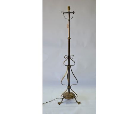 An Arts &amp; Crafts brass tripod standard lamp, converted from an original telescopic oil lamp, wired for UK electrical use,