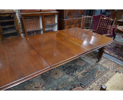 A Victorian mahogany extending wind-out dining table, the moulded edge top accepting two insert leaves, raised on turned moul