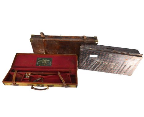 An antique brass bound leather gun case for E M Reilly &amp; Co. to/with a leather bound canvas gun case for A&amp;N Leather 